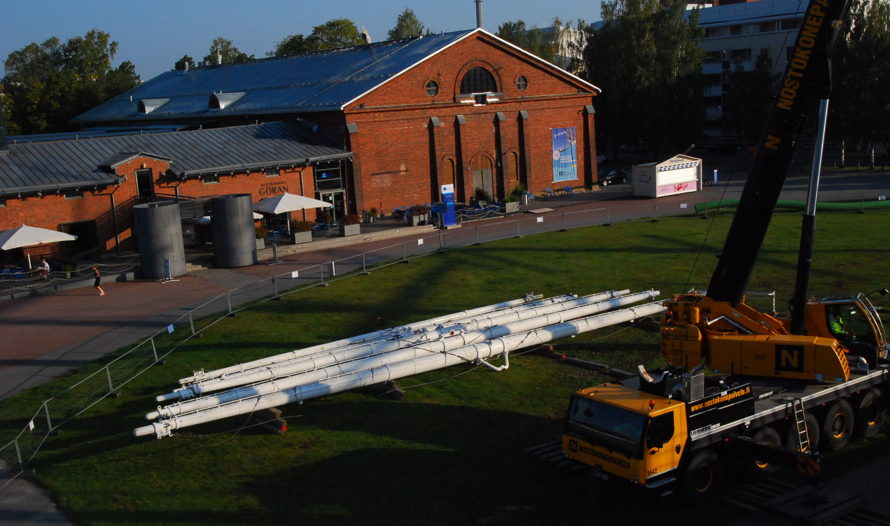 Maston osia nurmikolla, taustalla Kruununmakasiini.